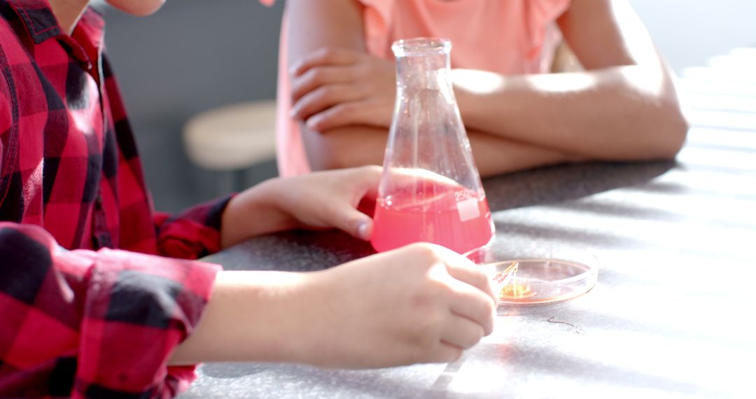 Young Student Conducts Exciting Science Experiment with Pink Liquid