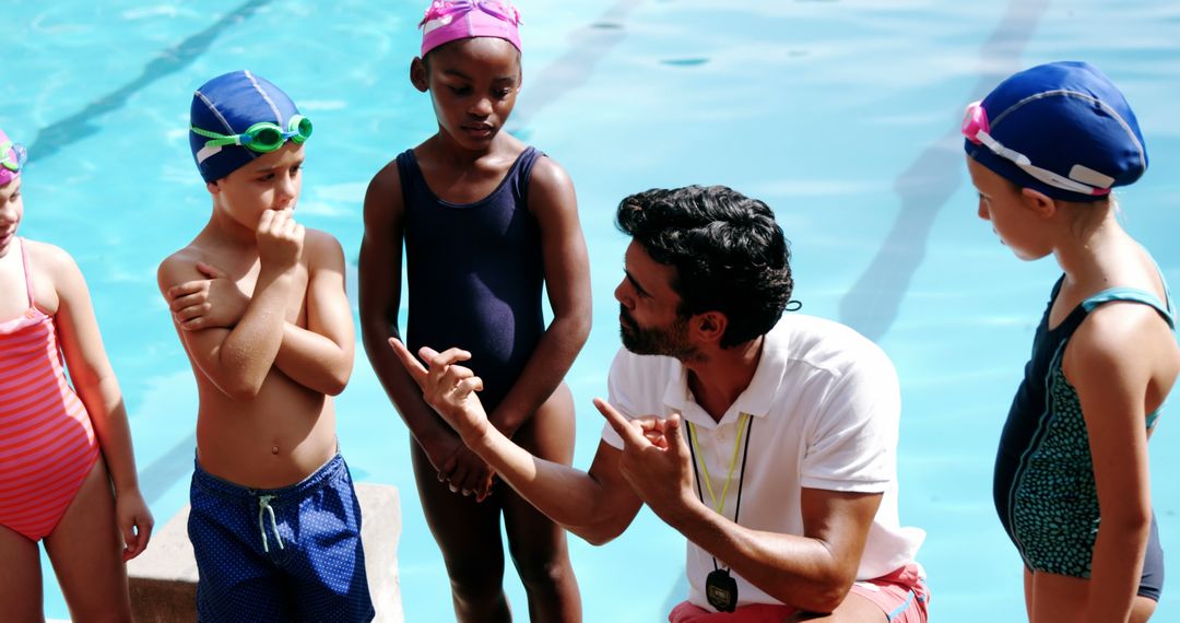 Swim Instructor Teaching Young Children at Poolside - Free Images, Stock Photos and Pictures on Pikwizard.com