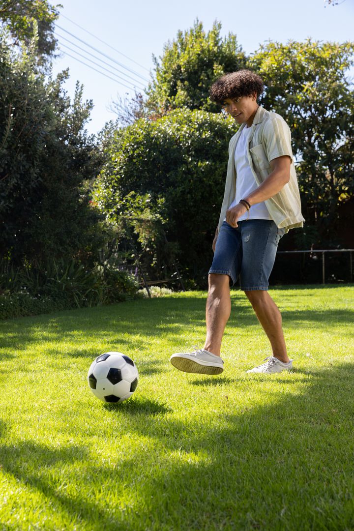 Young Man Enjoying Soccer at Home Garden
