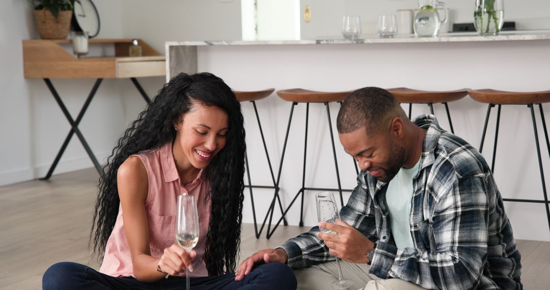 Happy Couple Drinking Champagne and Celebrating at Home