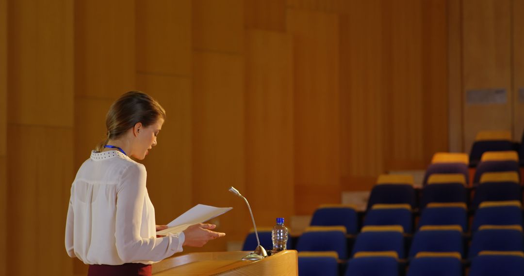 Businesswoman Practicing Speech in Empty Auditorium