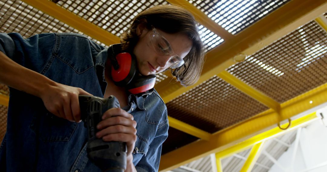 Female Carpenter Wearing Safety Gear Using Drill - Free Images, Stock Photos and Pictures on Pikwizard.com