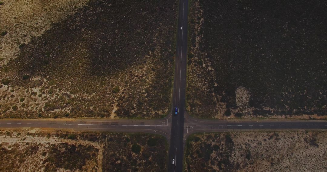 Aerial Intersection Crossing with Truck and Car on Arid Plain Two-Lane Highway