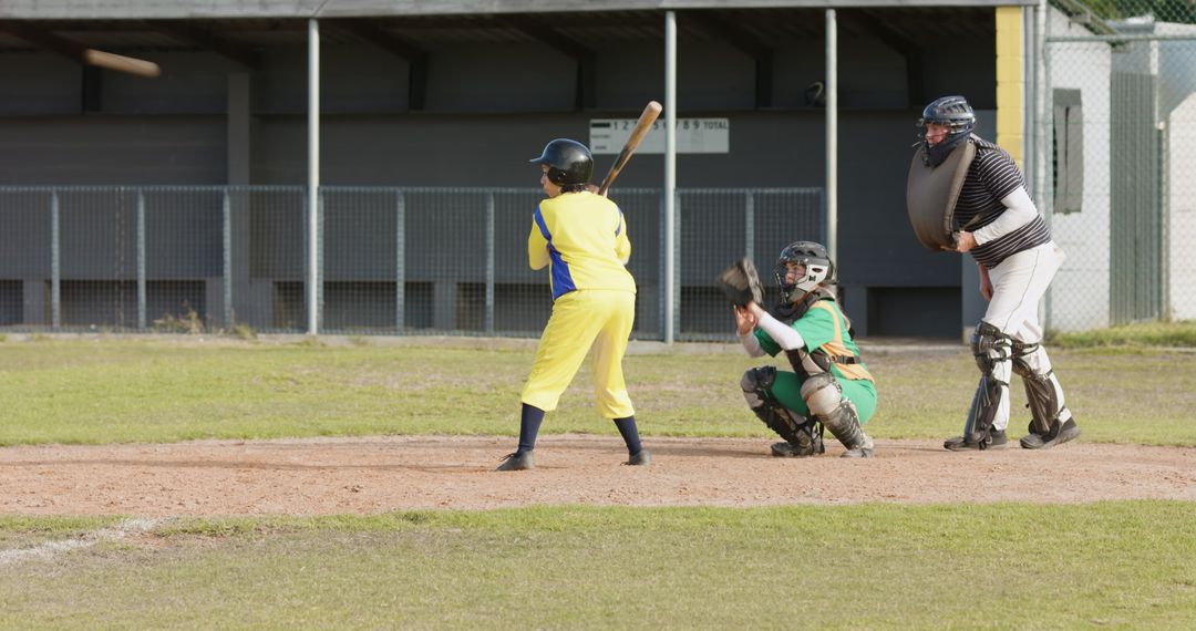 Youth Baseball Player Preparing to Bat During Game