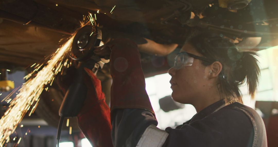 Female Mechanic Using Grinding Wheel with Sparks
