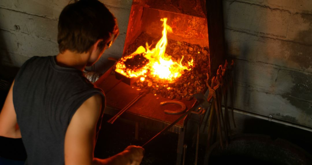 Blacksmith Shaping Metal in Forging Workshop - Free Images, Stock Photos and Pictures on Pikwizard.com