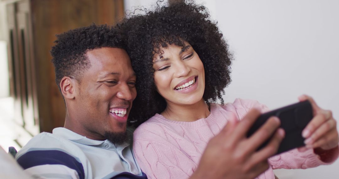 Happy Couple Enjoying Smartphone Time at Home
