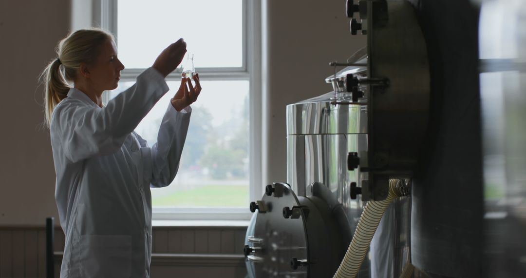 Female Scientist Examining Liquid Sample in Laboratory - Free Images, Stock Photos and Pictures on Pikwizard.com