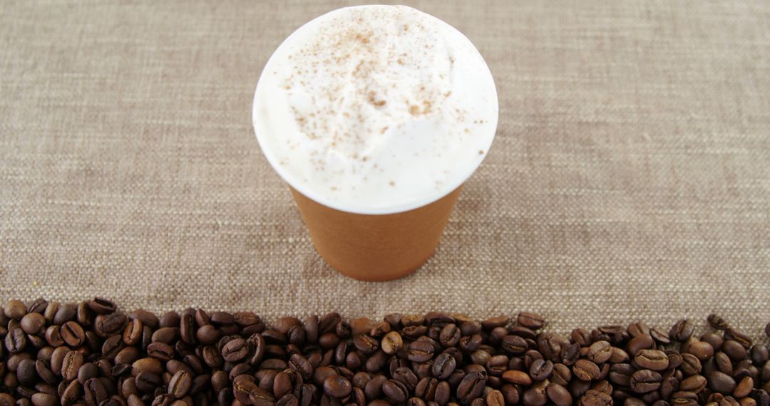 Cup of Cappuccino with Coffee Beans on Burlap Surface - Free Images, Stock Photos and Pictures on Pikwizard.com