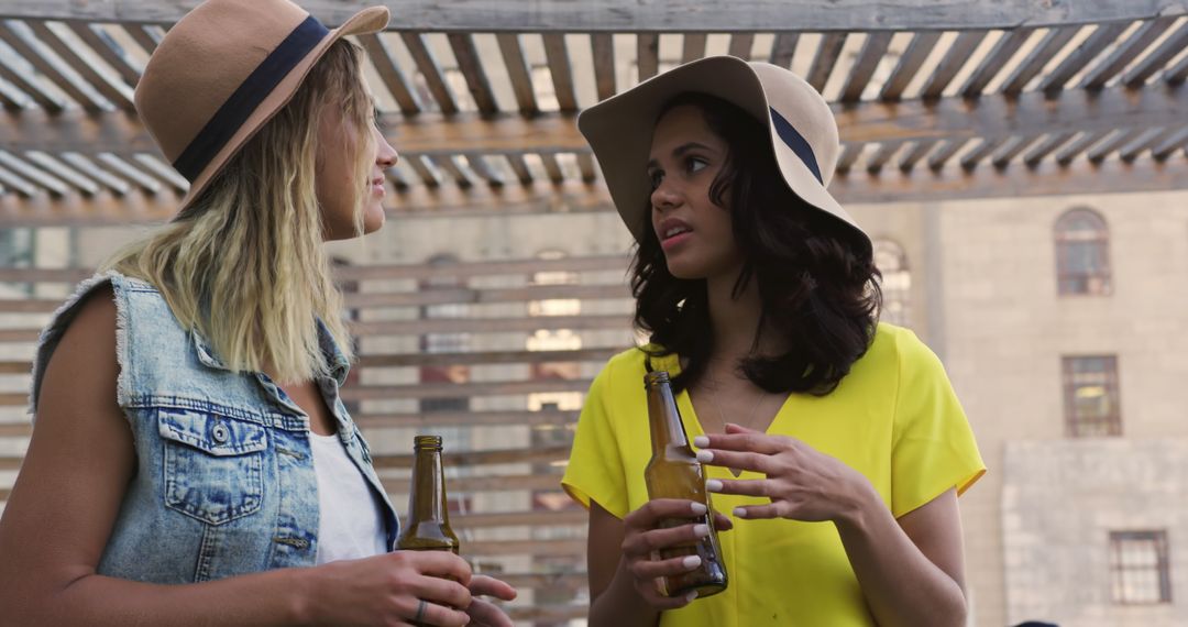 Two Friends Enjoying Drinks at Rooftop Party