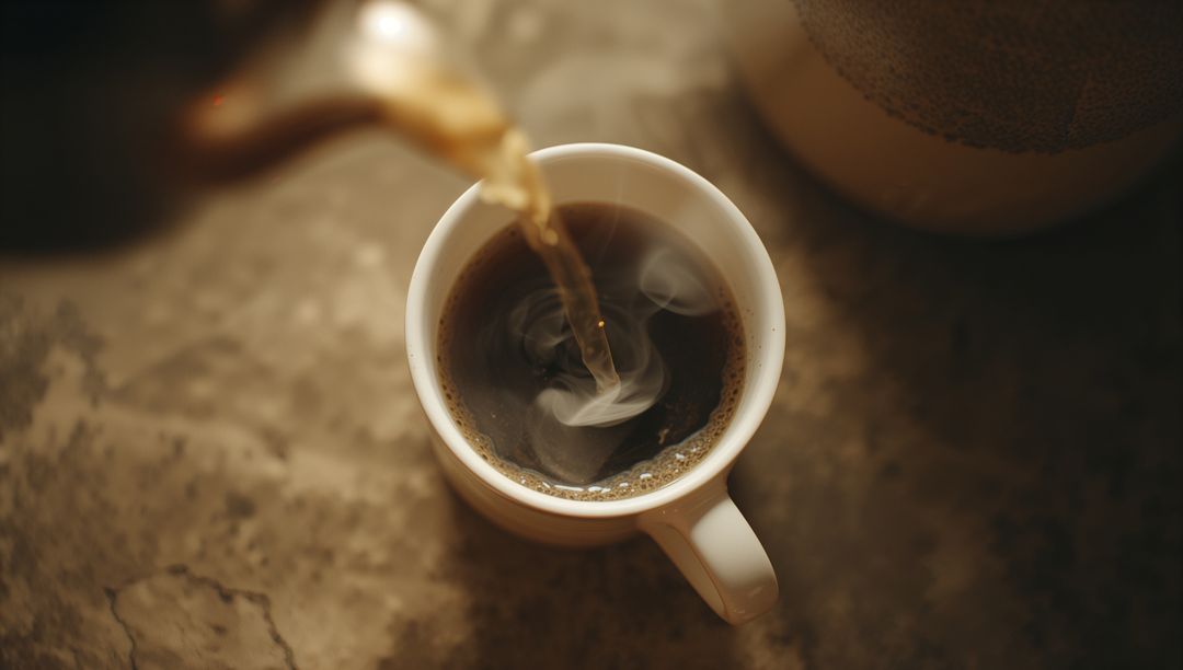 Pouring Hot Coffee into Ceramic Mug on Stone Surface