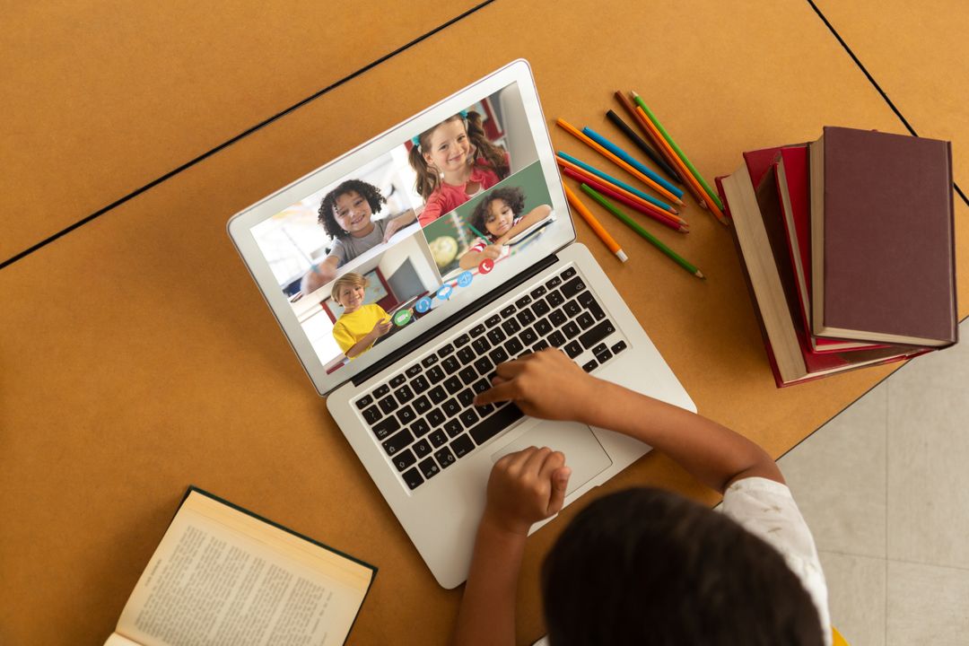 Biracial boy using laptop for video call, with diverse elementary school pupils on screen - Free Images, Stock Photos and Pictures on Pikwizard.com