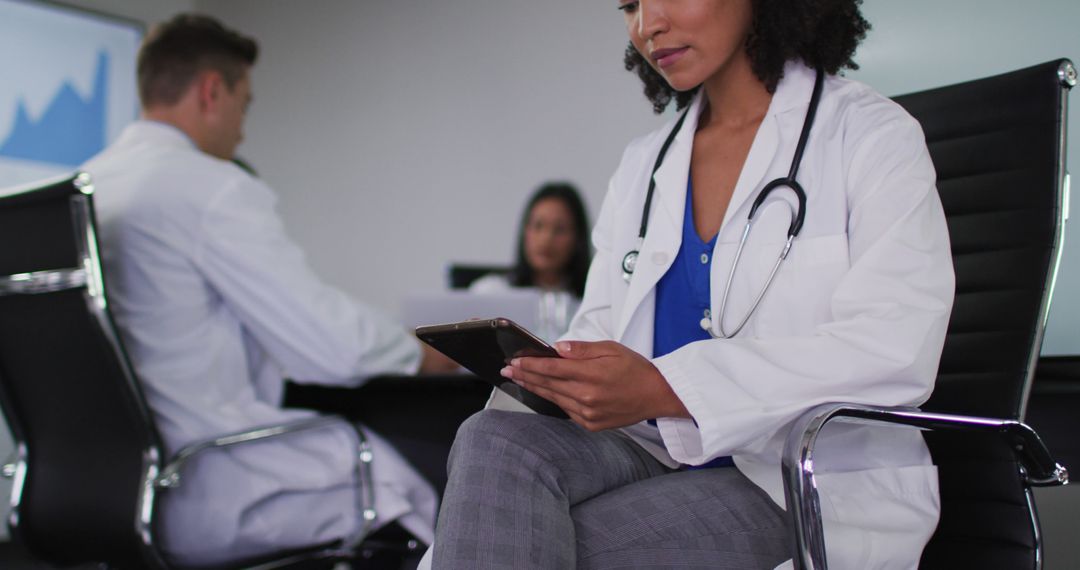 Doctor Using Digital Tablet During Healthcare Meeting - Free Images, Stock Photos and Pictures on Pikwizard.com