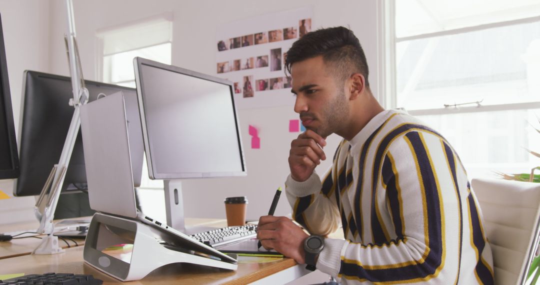 Biracial Male Creative Director Using Computer in Modern Office