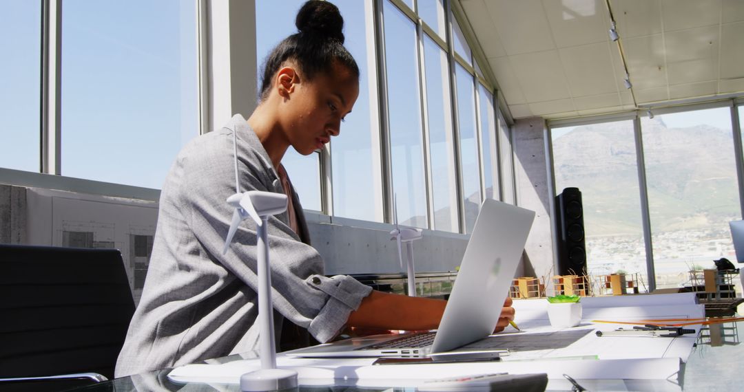 Businesswoman Analyzing Architectural Models in Modern Office