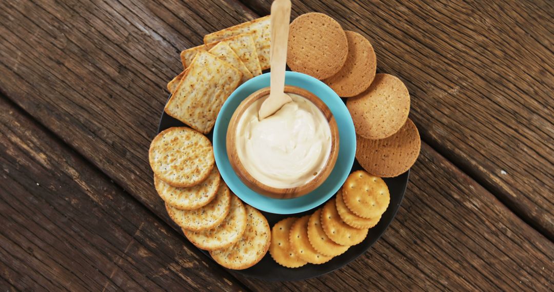 Assorted Crackers with Cream Cheese Dip on Rustic Wooden Table - Free Images, Stock Photos and Pictures on Pikwizard.com