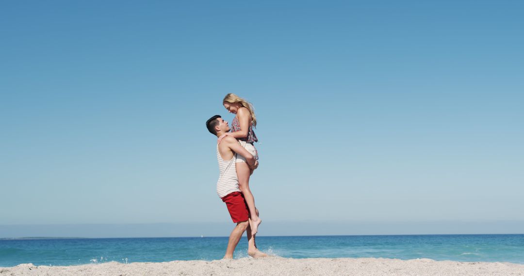 Joyful Couple Embracing On Sandy Beach Against Clear Sky - Free Images, Stock Photos and Pictures on Pikwizard.com