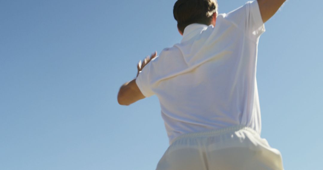 Male player in white cricket uniform throwing ball - Free Images, Stock Photos and Pictures on Pikwizard.com