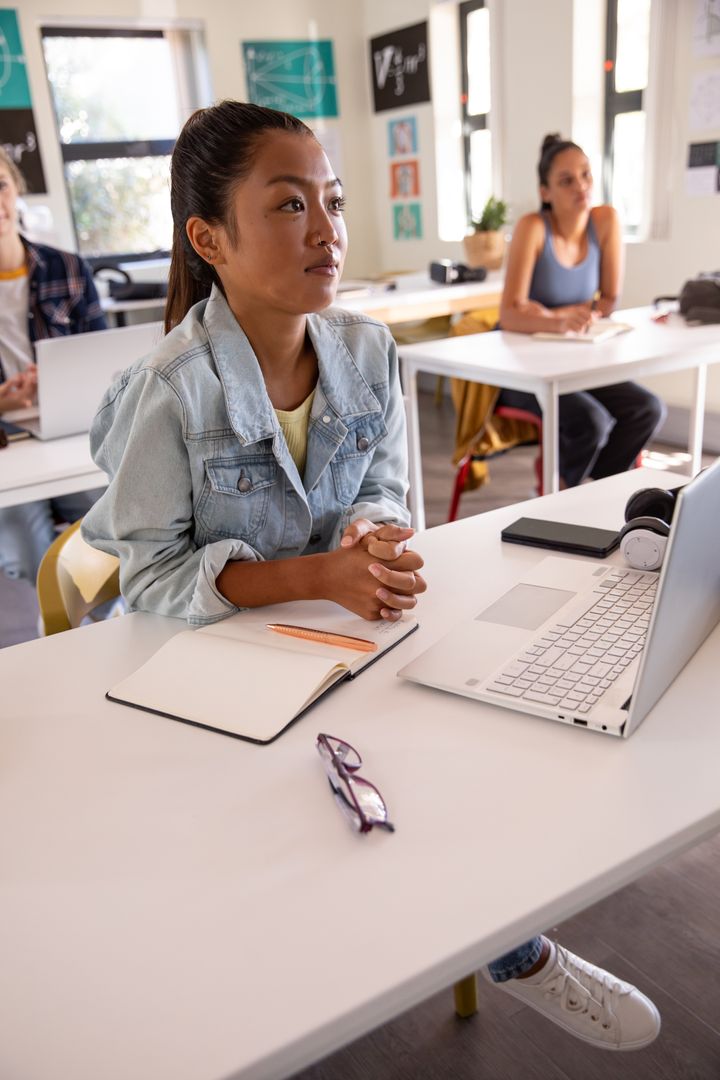 Diverse Students Studying in Modern Classroom with Laptops