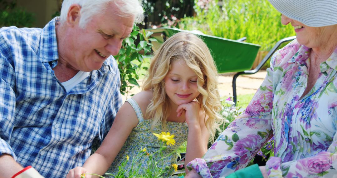 Happy Grandparents and Granddaughter Gardening Together Outdoors - Free Images, Stock Photos and Pictures on Pikwizard.com