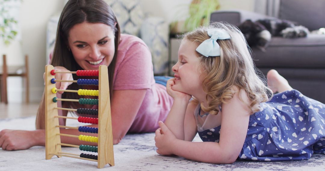 Mother and Daughter Playing with Abacus in Bright Living Room - Free Images, Stock Photos and Pictures on Pikwizard.com