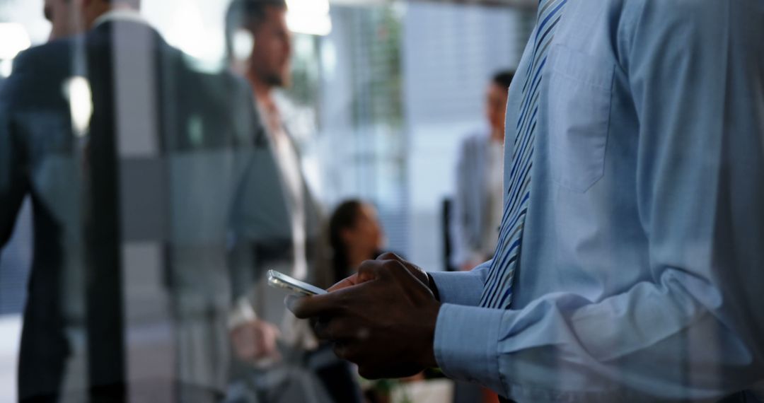 Business Professional Typing on Mobile Device in Modern Office