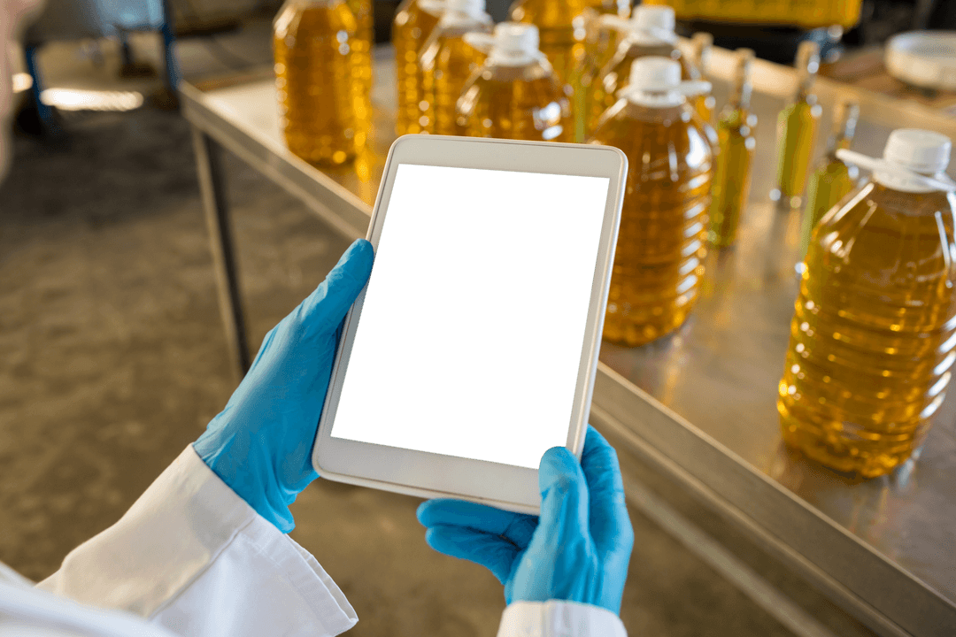 Technician Using Transparent Tablet in Oil Production Facility