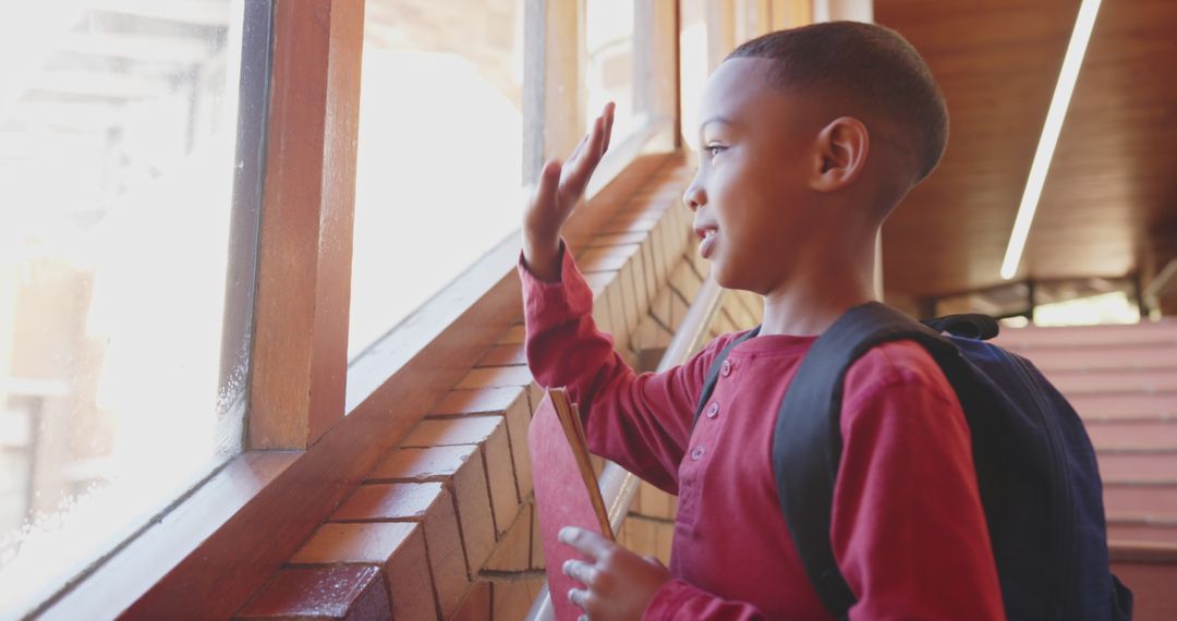 Cheerful Schoolboy Waving at Window Before Class
