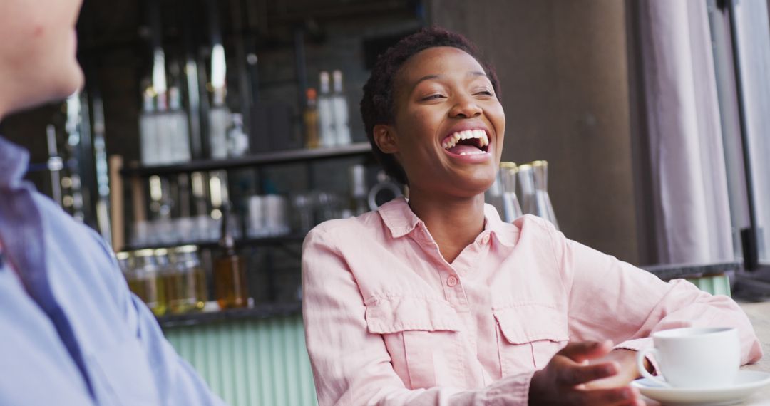 Woman Laughing While Enjoying A Coffee Break in Cafe - Free Images, Stock Photos and Pictures on Pikwizard.com