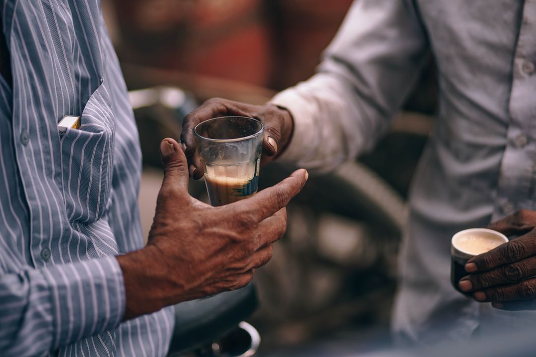 Close-up of Men Sharing Traditional Indian Chai Tea in Glass Cups - Free Images, Stock Photos and Pictures on Pikwizard.com