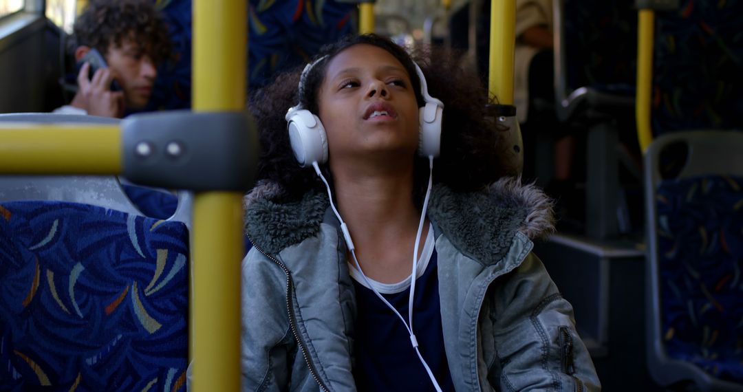 Child Enjoying Music on Bus with Headphones - Free Images, Stock Photos and Pictures on Pikwizard.com