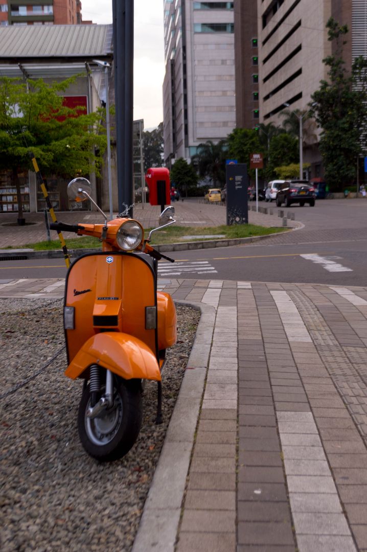 Vintage Orange Scooter Parked On Urban Street Corner - Free Images, Stock Photos and Pictures on Pikwizard.com