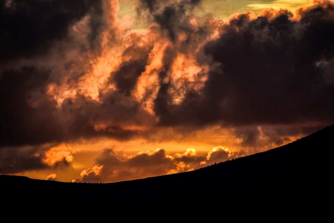 Vibrant Sunrise with Dramatic Clouds and Silhouetted Hills - Free Images, Stock Photos and Pictures on Pikwizard.com