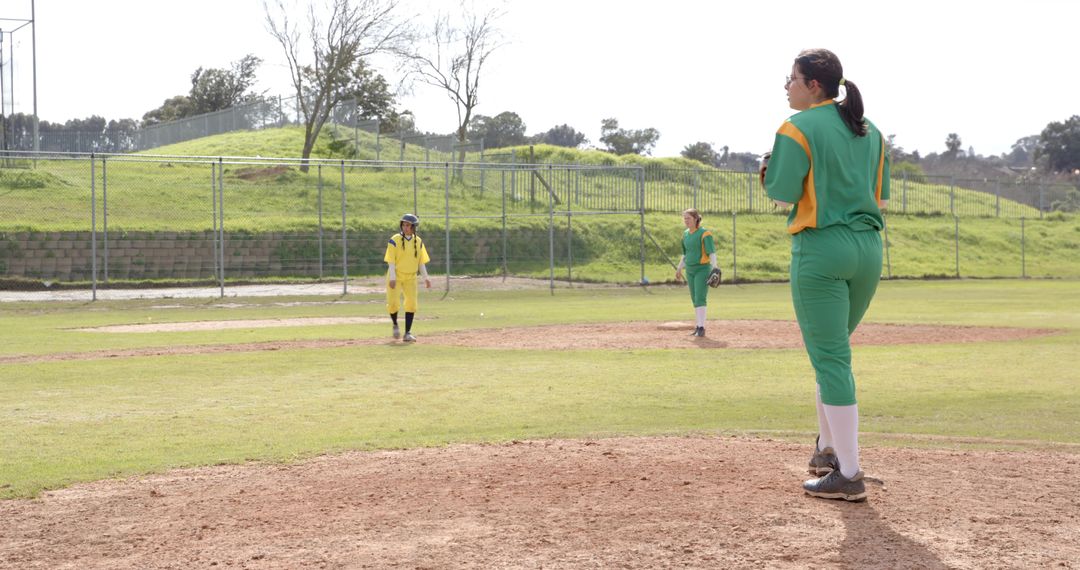 Female Softball Players Competing on Open Field in Spring