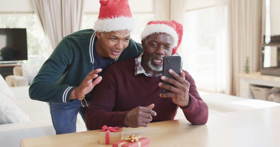 Father and Son Enjoy Christmas Video Call at Home - Free Images, Stock Photos and Pictures on Pikwizard.com