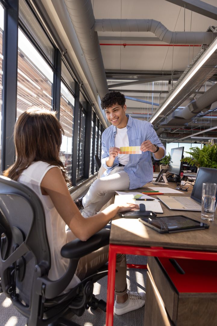 Creative Team Collaborating with Color Swatch in Modern Open-Plan Office