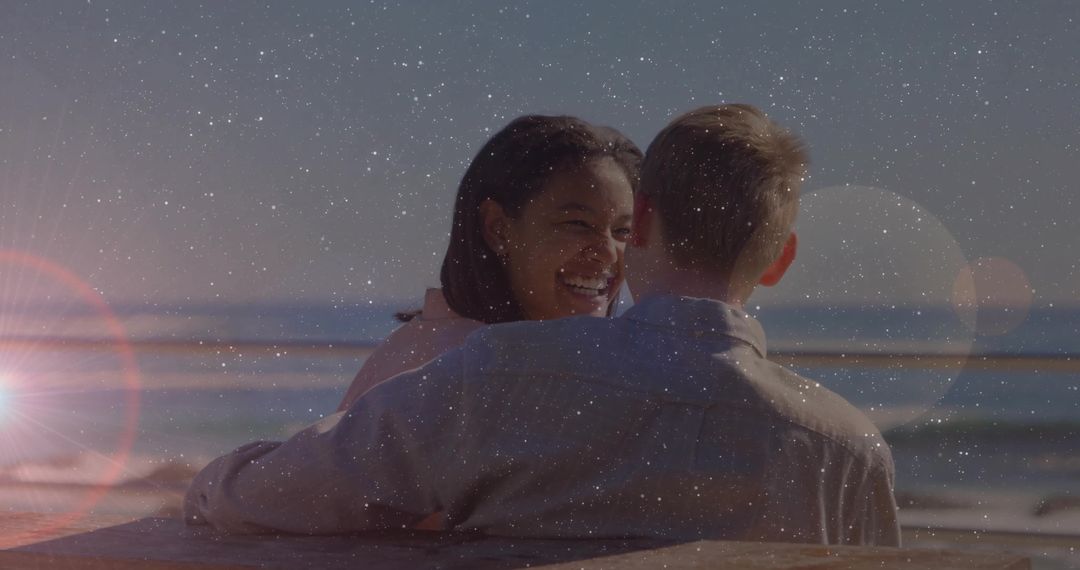 Romantic Multiracial Couple Embracing at Beach with Lens Flare Effect