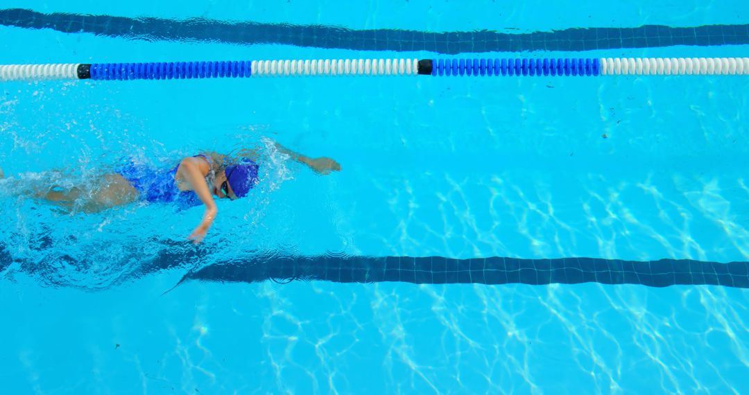 Swimmer in Blue Pool doing Front Crawl Stroke - Free Images, Stock Photos and Pictures on Pikwizard.com