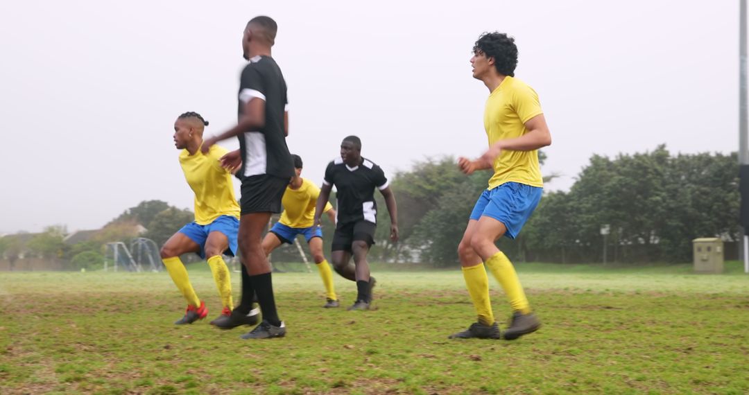 Dynamic Soccer Match with Diverse Athletes on Misty Field