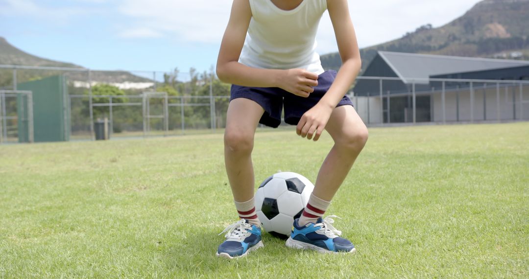 Young Child Practicing Ball Control on Soccer Field