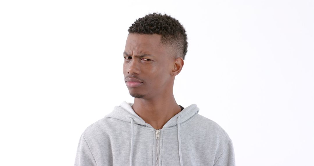 Young Man in Hoodie Expressing Confusion