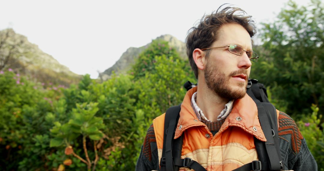 Man Hiking Through Lush Scenic Mountains