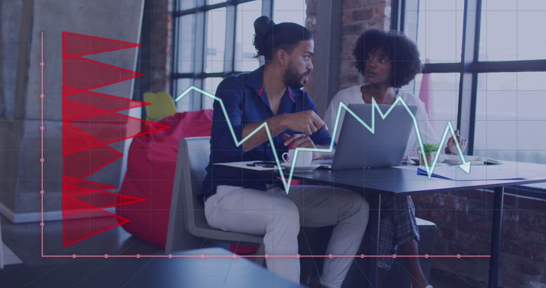 Diverse Business Team Analyzing Graphs on Laptop