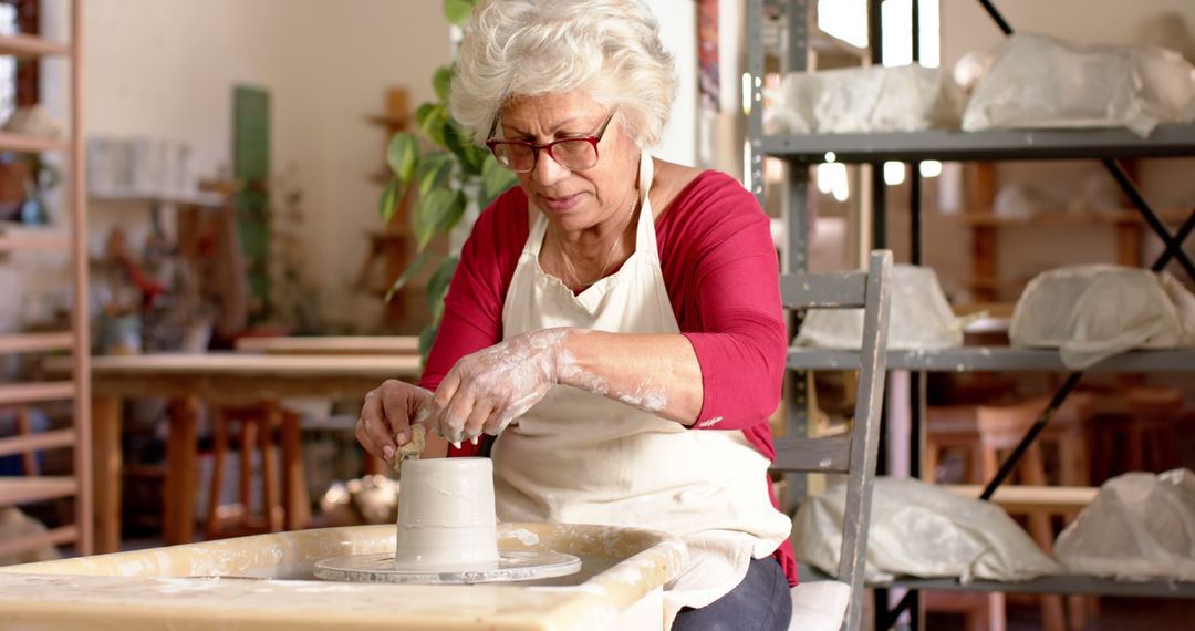 Senior Woman Creating Pottery in Ceramic Studio - Free Images, Stock Photos and Pictures on Pikwizard.com