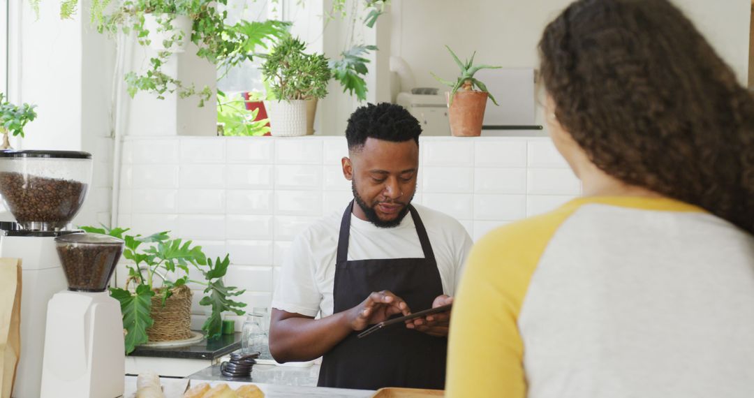 Friendly Barista Assisting Customer in Cozy Cafe