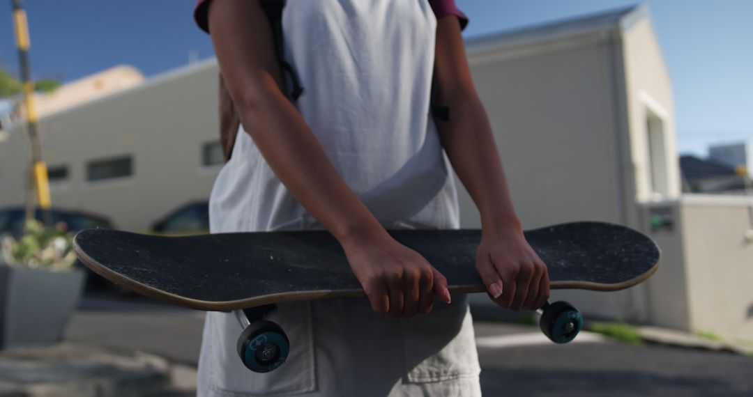 Close-Up of Individual Holding Skateboard in Urban Environment - Free Images, Stock Photos and Pictures on Pikwizard.com