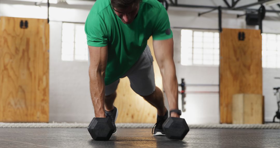 Man Exercising with Dumbbells in Modern Gym - Free Images, Stock Photos and Pictures on Pikwizard.com