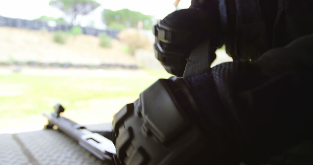 Soldier Preparing for Training with Rifles
