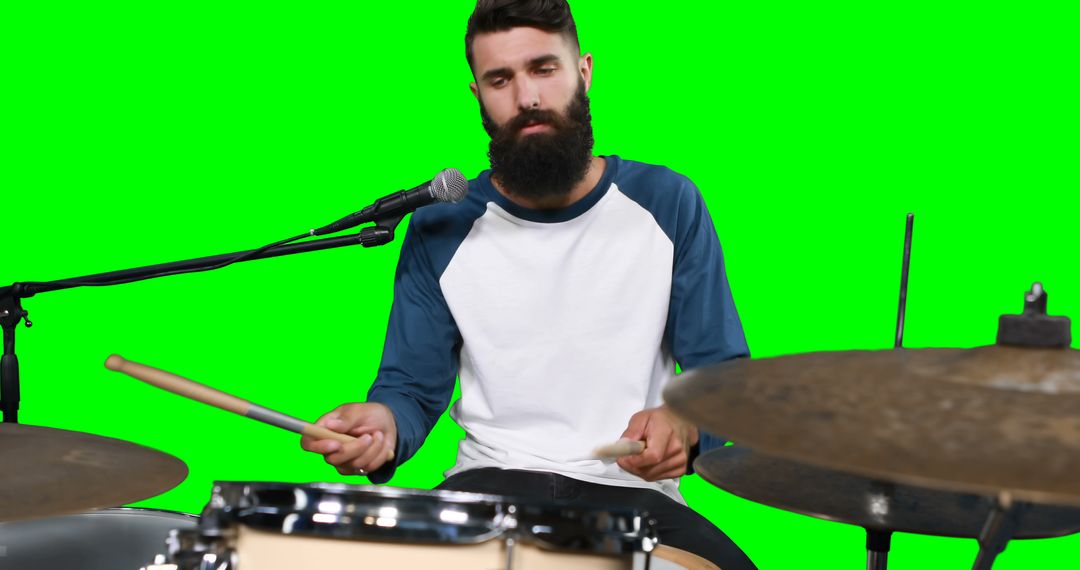 Male drumer playing drum against green screen - Free Images, Stock Photos and Pictures on Pikwizard.com