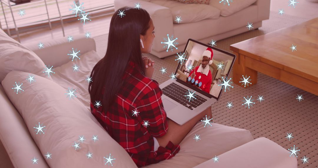 Woman in Video Call with Santa at Christmas amid Snowfall Effects